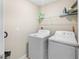 Bright laundry room complete with white washer and dryer at 9313 Lemon Drop Loop, Ruskin, FL 33573