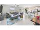 Spacious open-concept living room with tile flooring and large windows with natural light at 9313 Lemon Drop Loop, Ruskin, FL 33573