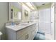 Bathroom featuring double sinks, a granite countertop, and a decorative mirror at 9930 121 N St, Seminole, FL 33772