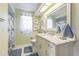 Bathroom featuring granite countertop, vanity, tile floors, and nautical décor at 9930 121 N St, Seminole, FL 33772