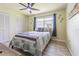 Bedroom featuring window with backyard view, ceiling fan, and closet at 9930 121 N St, Seminole, FL 33772