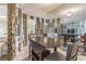 Dining area with rock walls, mirrored walls, and a view of the open-concept living space at 9930 121 N St, Seminole, FL 33772