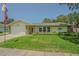 Inviting single-story home with lush front lawn and attached garage on a sunny day at 9930 121 N St, Seminole, FL 33772