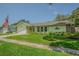 Lovely single-story home with well-kept lawn, stone detail, and an attached garage at 9930 121 N St, Seminole, FL 33772