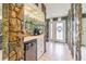Hallway features unique rock walls, a mirrored bar, and access to the front door at 9930 121 N St, Seminole, FL 33772