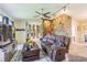 Inviting living room features a stone accent wall, ceiling fan, and an open floor plan at 9930 121 N St, Seminole, FL 33772