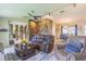 Open-concept living room showcases a stone accent wall, a ceiling fan, and comfortable furnishings at 9930 121 N St, Seminole, FL 33772