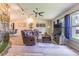 Comfortable living room features a stone accent wall, ceiling fan, and natural light at 9930 121 N St, Seminole, FL 33772