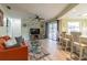 Inviting living room with sliding glass doors and bar seating that connects to the kitchen at 9930 121 N St, Seminole, FL 33772