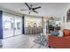 Open-concept living room featuring a breakfast bar, ceiling fan, and sliding glass doors to the lanai at 9930 121 N St, Seminole, FL 33772