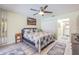 Main bedroom featuring bed, decorative mirror, ceiling fan, and ensuite bathroom at 9930 121 N St, Seminole, FL 33772