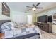 Spacious main bedroom with a ceiling fan, closet, and a mirrored wall with an entertainment center at 9930 121 N St, Seminole, FL 33772