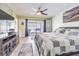 Main bedroom with ceiling fan, closet, backyard views, and an entertainment center at 9930 121 N St, Seminole, FL 33772