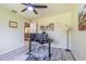 Office featuring modern desk, large window, ceiling fan, and decorative art at 9930 121 N St, Seminole, FL 33772