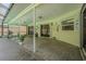 Spacious covered patio with neutral colors and lighting, ideal for relaxation and outdoor living at 9930 121 N St, Seminole, FL 33772