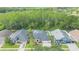 Aerial view of a neighborhood with mature trees and a home with a screened-in pool at 10002 Colonnade Dr, Tampa, FL 33647