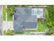 An aerial view showcasing roof, lawn, backyard and pool of the home at 10002 Colonnade Dr, Tampa, FL 33647