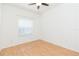 Minimalist bedroom with laminate floors, neutral walls, and natural light from one window at 10002 Colonnade Dr, Tampa, FL 33647
