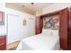 Bedroom with a murphy bed, white closet, colorful painting, and hardwood floors at 10002 Colonnade Dr, Tampa, FL 33647