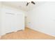 Bright bedroom featuring a ceiling fan, hardwood floors, and white closets for ample storage at 10002 Colonnade Dr, Tampa, FL 33647
