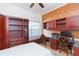 Cozy bedroom with a mounted workstation, cabinets, a window bench, and a ceiling fan at 10002 Colonnade Dr, Tampa, FL 33647