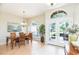 Bright dining area with a wooden table, natural light, and a view of the outdoors through French doors at 10002 Colonnade Dr, Tampa, FL 33647