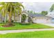 Charming single-story home with a well-manicured lawn, mature landscaping, and an attached three-car garage at 10002 Colonnade Dr, Tampa, FL 33647