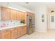 Kitchen with stainless steel fridge, tile floors, and neutral counters with tile backsplash details at 10002 Colonnade Dr, Tampa, FL 33647