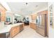 Well-lit kitchen featuring stainless steel appliances, tile flooring, and open floor plan at 10002 Colonnade Dr, Tampa, FL 33647