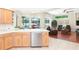 Open kitchen offering views of the breakfast nook, living room and screened-in pool at 10002 Colonnade Dr, Tampa, FL 33647