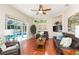 Bright living room with views of the pool area and comfortable leather furnishings at 10002 Colonnade Dr, Tampa, FL 33647
