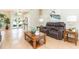 Cozy living room featuring hardwood floors, neutral paint, and elegant furnishings with front door and transom at 10002 Colonnade Dr, Tampa, FL 33647