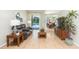 Cozy living room features a leather sofa and views of the outdoor pool area and the adjacent dining space at 10002 Colonnade Dr, Tampa, FL 33647