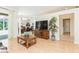 Bright living room with wood-style flooring, a TV, and an open layout leading to the dining and outdoor areas at 10002 Colonnade Dr, Tampa, FL 33647
