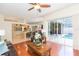 Cozy living room featuring hardwood floors and sliding glass doors to the pool area at 10002 Colonnade Dr, Tampa, FL 33647