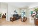 Comfortable living room with a leather sofa, wood-style flooring, and a view of the pool area at 10002 Colonnade Dr, Tampa, FL 33647
