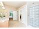 Bright bathroom with a walk-in shower and view to bedroom and pool area at 10002 Colonnade Dr, Tampa, FL 33647