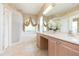 Luxury main bathroom with dual vanities, tiled floors, and a walk-in shower at 10002 Colonnade Dr, Tampa, FL 33647