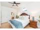 Bright main bedroom boasting wood floors, a decorative window, and ensuite bathroom access at 10002 Colonnade Dr, Tampa, FL 33647