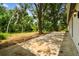 A large backyard patio area surrounded by mature trees, providing a secluded feel at 103 Hickory Creek Blvd, Brandon, FL 33511