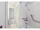 Bathroom featuring a white tile shower/tub combo and accessibility handrails at 103 Hickory Creek Blvd, Brandon, FL 33511