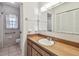 Bathroom featuring a tile floor, wood vanity, large mirror, and a shower/tub combo at 103 Hickory Creek Blvd, Brandon, FL 33511