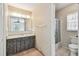 Bathroom featuring a vanity with drawers, wallpaper, and a separate shower space at 103 Hickory Creek Blvd, Brandon, FL 33511