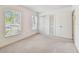 Bedroom with neutral carpet, a large closet, and two windows at 103 Hickory Creek Blvd, Brandon, FL 33511