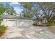 Spacious driveway connects garage and house, shaded by mature trees at 103 Hickory Creek Blvd, Brandon, FL 33511
