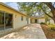 Exterior shot featuring the side and back of the house with a concrete patio and mature trees at 103 Hickory Creek Blvd, Brandon, FL 33511