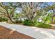 Charming single-story home with mature trees and landscaped front yard along concrete driveway at 103 Hickory Creek Blvd, Brandon, FL 33511