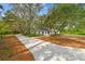 A charming home with a long driveway and mature trees offering both curb appeal and privacy at 103 Hickory Creek Blvd, Brandon, FL 33511