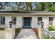 Inviting front entrance with brick columns, decorative lanterns, and a classic painted double door at 103 Hickory Creek Blvd, Brandon, FL 33511