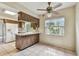A eat-in kitchen features wood cabinets, tile flooring, and stainless steel appliances at 103 Hickory Creek Blvd, Brandon, FL 33511
